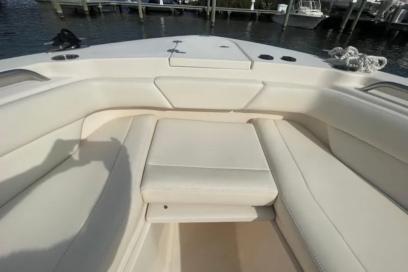 Slide: The Image of 2021 Grady-White Canyon 271 boat interior with white cushioned seating. - 16