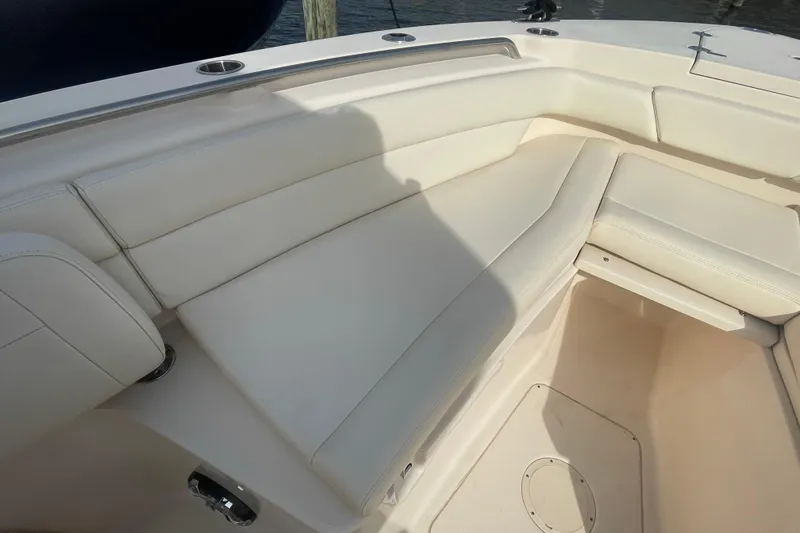 Slide: The Image of 2021 Grady-White Canyon 271 boat interior with white cushioned seating. - 17