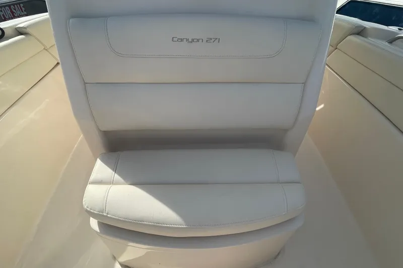 Slide: The Image of 2021 Grady-White Canyon 271 boat seat, white upholstery, sleek design. - 21