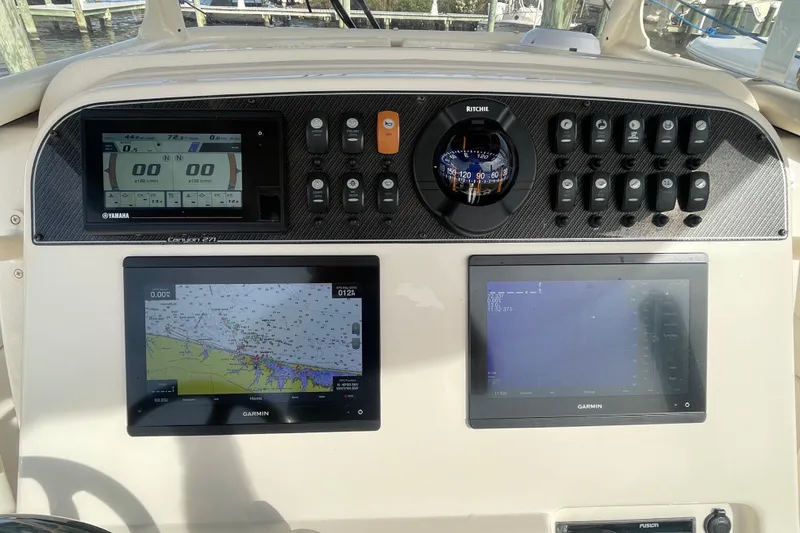 Slide: The Image of Grady-White Canyon 271 dashboard with Garmin displays and Yamaha controls, 2021 model. - 23