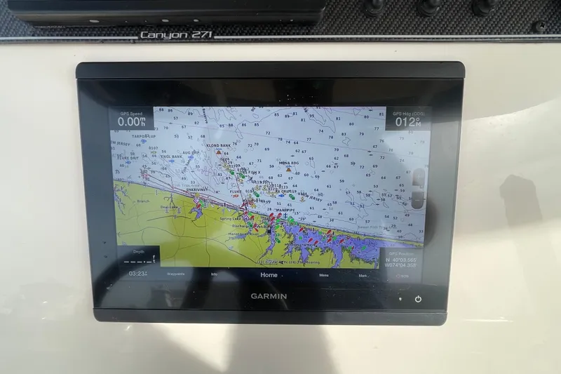 Slide: The Image of Garmin GPS display on 2021 Grady-White Canyon 271 boat dashboard. - 24