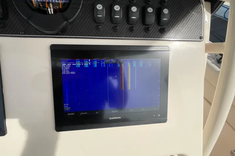 Slide: The Image of Garmin display on 2021 Grady-White Canyon 271 boat dashboard, showing sonar data. - 25
