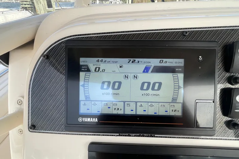 Slide: The Image of Yamaha display on 2021 Grady-White Canyon 271 boat dashboard, showing speed and fuel data. - 27