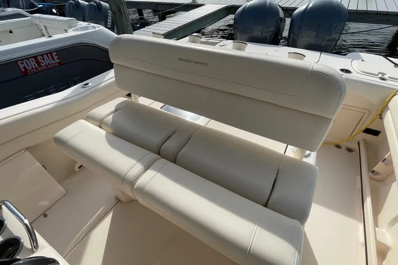 Slide: The Image of 2021 Grady-White Canyon 271 boat interior with cushioned seating and dual engines. - 34