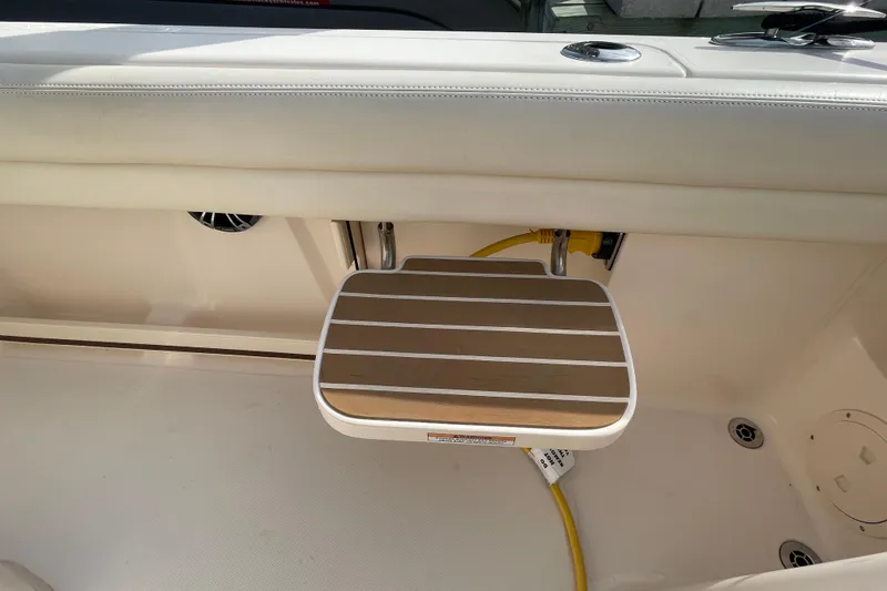 Slide: The Image of 2021 Grady-White Canyon 271 boat interior with wooden step and yellow cable. - 35