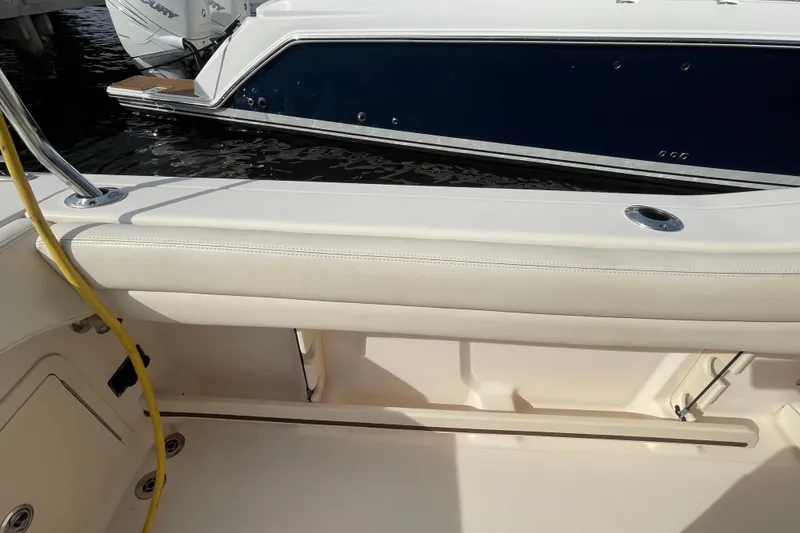 Slide: The Image of 2021 Grady-White Canyon 271 boat interior with cushioned seating and sleek design. - 37