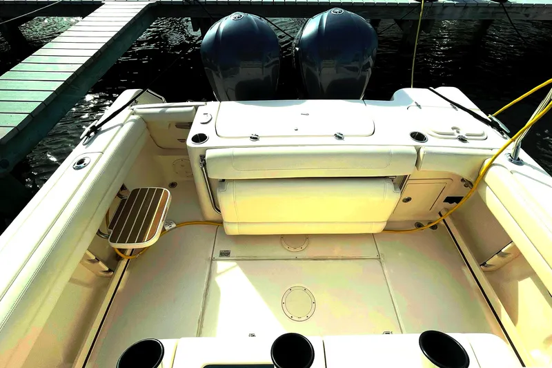 Slide: The Image of 2021 Grady-White Canyon 271 boat interior with dual engines, docked at marina. - 39
