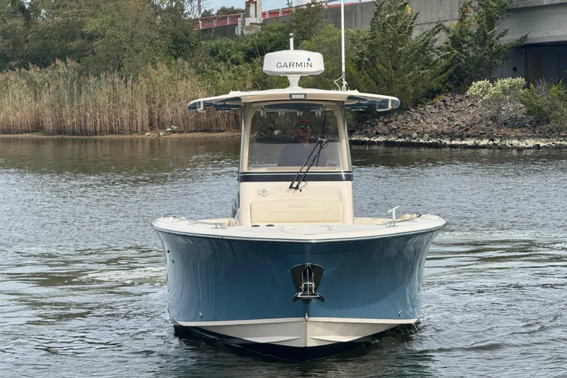 Slide: The Image of 2021 Grady-White Canyon 271 boat on water, featuring Garmin equipment. - 4