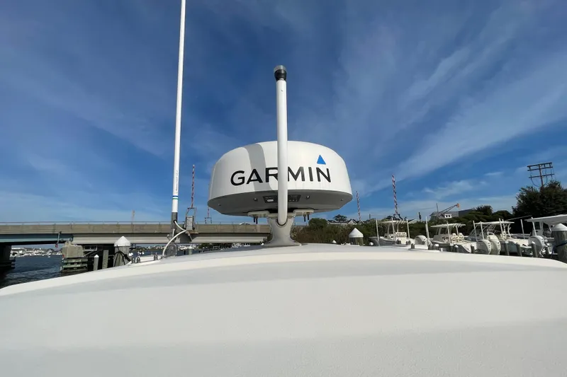 Slide: The Image of 2021 Grady-White Canyon 271 with Garmin radar, docked under clear blue sky. - 41