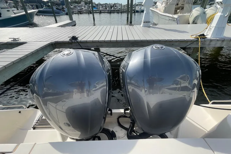 Slide: The Image of Twin outboard engines on a 2021 Grady-White Canyon 271 at a marina dock. - 44