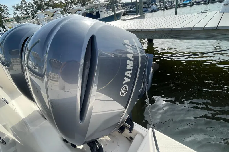 Slide: The Image of Twin Yamaha outboard engines on a 2021 Grady-White Canyon 271 boat at a marina. - 45