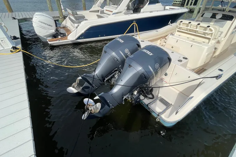 Slide: The Image of 2021 Grady-White Canyon 271 boat with dual Yamaha 300 engines docked at marina. - 47