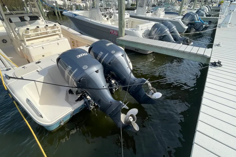 Slide: The Image of 2021 Grady-White Canyon 271 boat with twin Yamaha 300 engines docked at marina. - 48