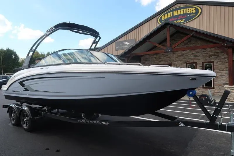 Slide: The Image of 2026 Chaparral 23 SSi boat on trailer in parking lot, under clear blue sky. - 2