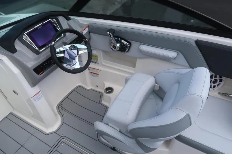 Slide: The Image of Control panel of 2026 Chaparral 23 SSi boat with switches and steering wheel. - 46