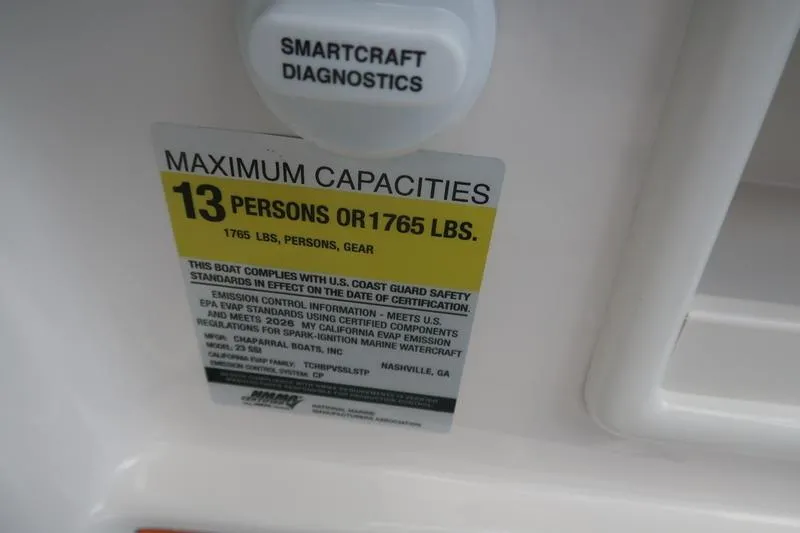 Slide: The Image of 2026 Chaparral 23 SSi boat storage compartment with cushioned seating and speaker. - 51