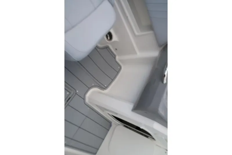 Slide: The Image of Interior seating of 2026 Chaparral 23 SSi boat with table and cushioned seats. - 55
