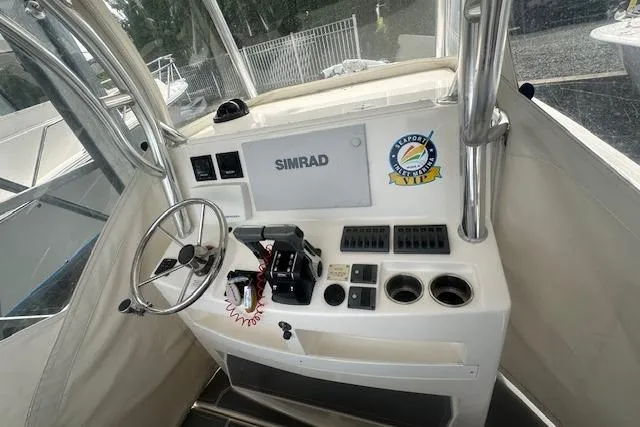 Slide: The Image of 2017 NorthCoast 260 CC boat helm with Simrad electronics and steering wheel. - 3