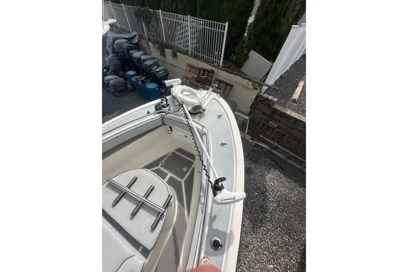 Slide: The Image of 2017 NorthCoast 260 CC boat deck with railing and equipment, parked on gravel. - 4