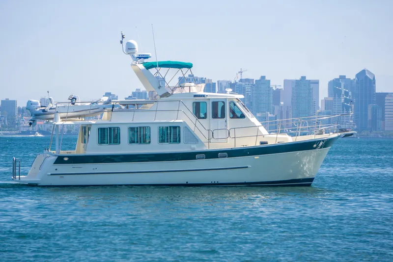 The Image of 2008 North Pacific 43 Pilothouse yacht cruising near city skyline. - 0