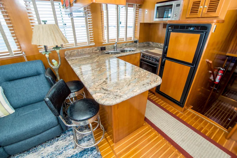 Slide: The Image of Luxurious 2008 North Pacific 43 Pilothouse interior with modern kitchen and seating area. - 11