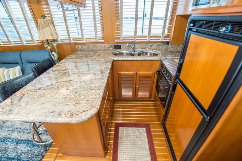 Slide: The Image of Luxurious 2008 North Pacific 43 Pilothouse yacht interior with granite countertops and wooden cabinetry. - 12
