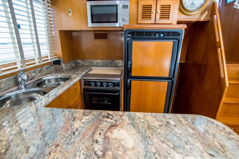 Slide: The Image of Luxurious kitchen in 2008 North Pacific 43 Pilothouse yacht with granite countertops and modern appliances. - 13