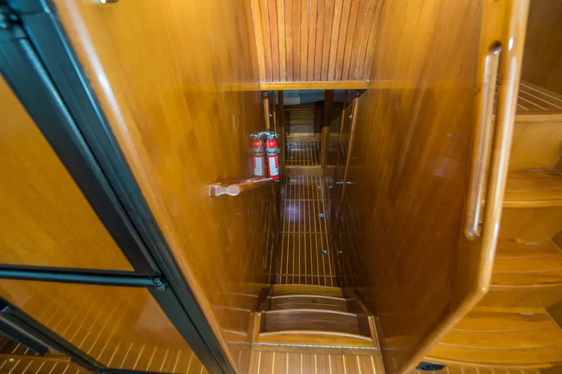 Slide: The Image of Wooden interior of 2008 North Pacific 43 Pilothouse with fire extinguishers and stairs. - 15