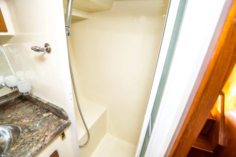 Slide: The Image of 2008 North Pacific 43 Pilothouse shower with marble countertop and handheld showerhead. - 19
