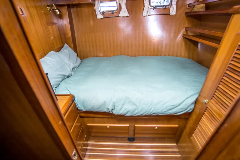Slide: The Image of Cozy cabin interior of 2008 North Pacific 43 Pilothouse with wooden finish and bed. - 20