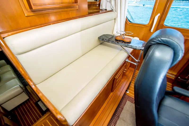 Slide: The Image of Luxurious interior of 2008 North Pacific 43 Pilothouse with leather seating and wooden accents. - 24