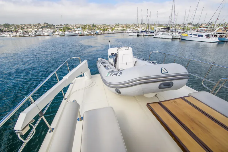 Slide: The Image of 2008 North Pacific 43 Pilothouse yacht with inflatable boat on deck, docked in marina. - 30