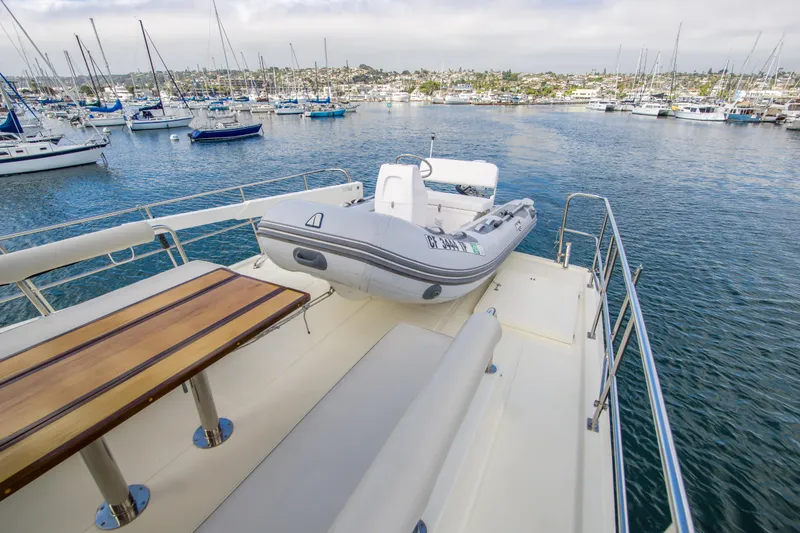 Slide: The Image of 2008 North Pacific 43 Pilothouse yacht deck with tender, overlooking marina. - 31