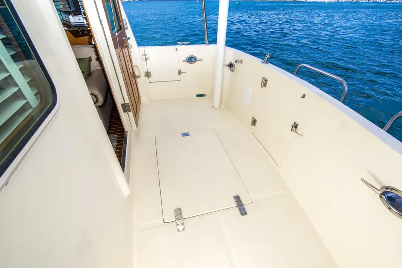 Slide: The Image of 2008 North Pacific 43 Pilothouse deck with ocean view and open cabin door. - 32