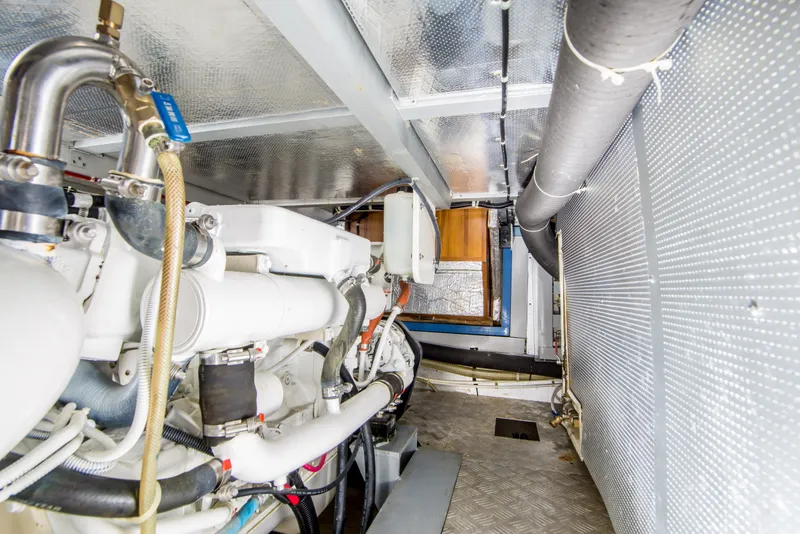 Slide: The Image of Engine room of 2008 North Pacific 43 Pilothouse, showcasing mechanical components and piping. - 38