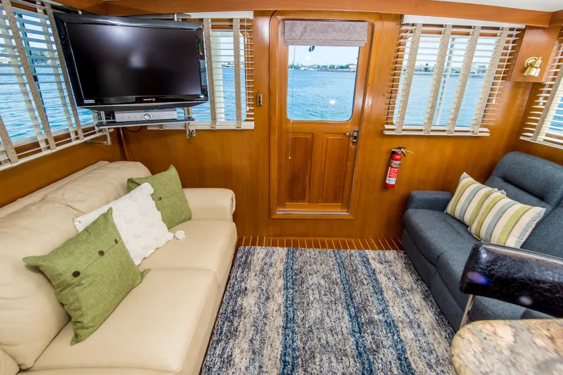 Slide: The Image of Interior of 2008 North Pacific 43 Pilothouse with cozy seating, TV, and ocean view. - 7