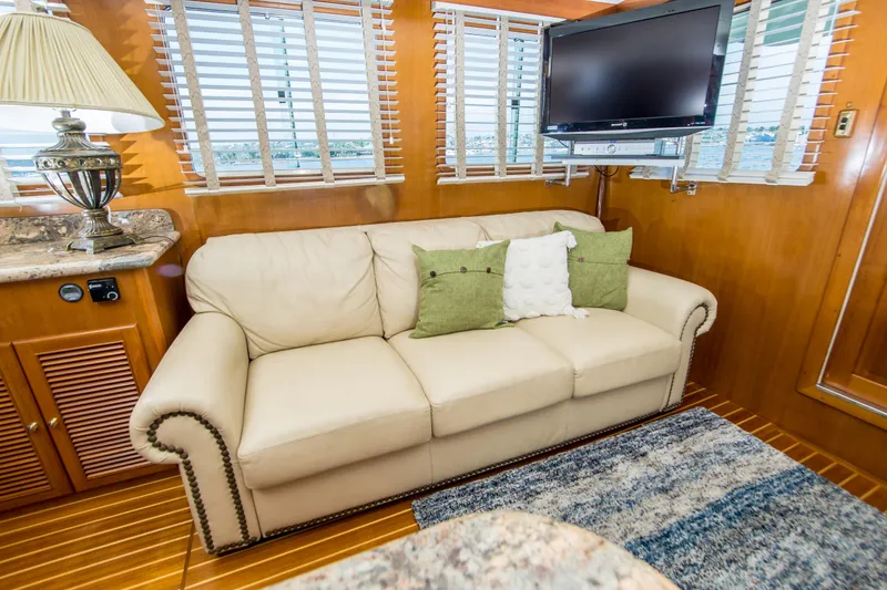Slide: The Image of Luxurious interior of 2008 North Pacific 43 Pilothouse with beige sofa and TV. - 8
