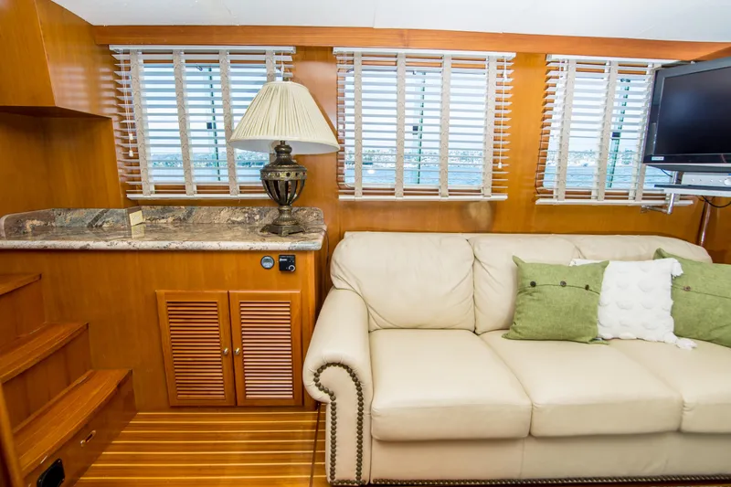 Slide: The Image of Interior of 2008 North Pacific 43 Pilothouse with sofa, lamp, and TV. - 9