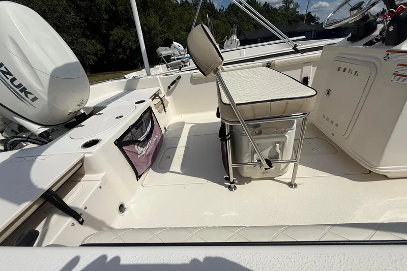 Slide: The Image of 2020 Carolina Skiff 19 LS boat interior with Suzuki engine and seating area. - 10