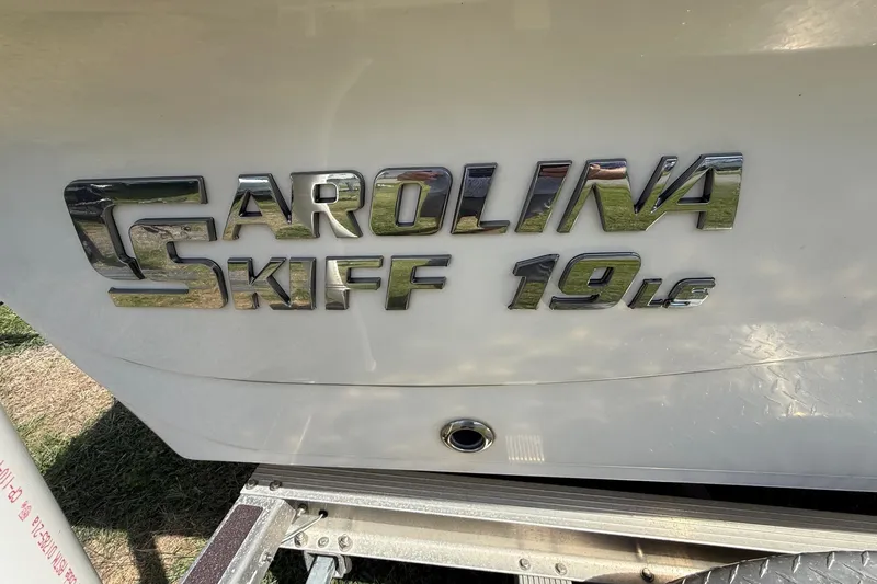 Slide: The Image of 2020 Carolina Skiff 19 LS boat logo on white hull, close-up view. - 11