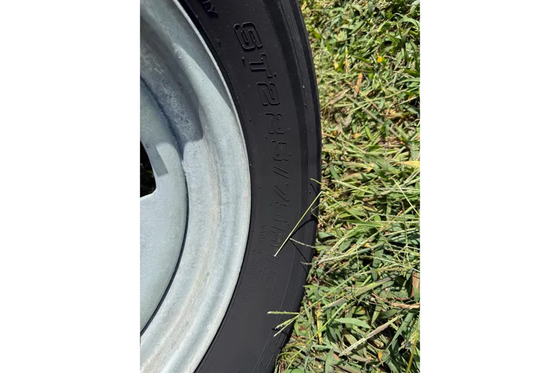 Slide: The Image of Close-up of a tire on grass, Carolina Skiff 19 LS 2020 model. - 13