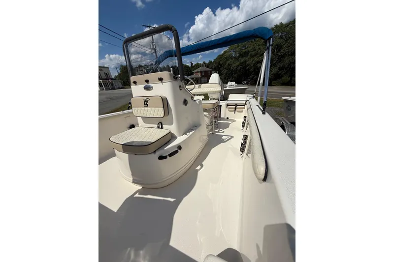 Slide: The Image of 2020 Carolina Skiff 19 LS boat interior with seating and console under blue sky. - 18