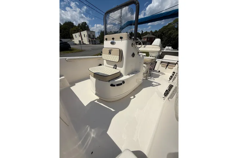 Slide: The Image of 2020 Carolina Skiff 19 LS boat interior with seating and console under blue sky. - 20
