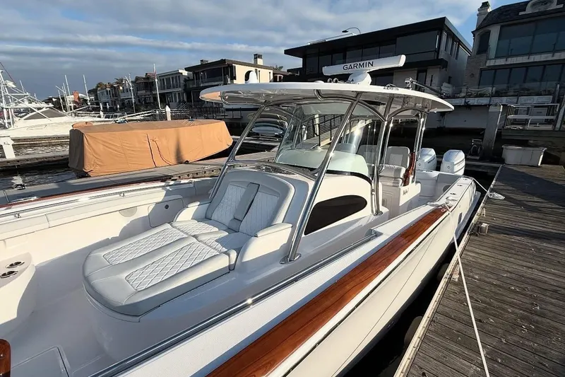 Slide: The Image of 2026 Mag Bay 38 CC boat docked, featuring sleek design and luxurious seating. - 2