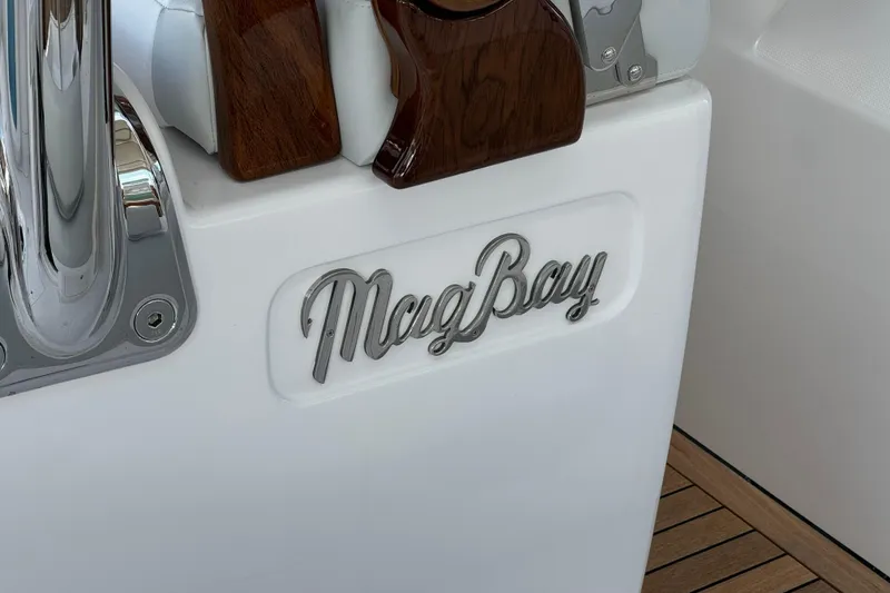 Slide: The Image of 2026 Mag Bay 38 CC boat interior with logo and wood accents. - 6