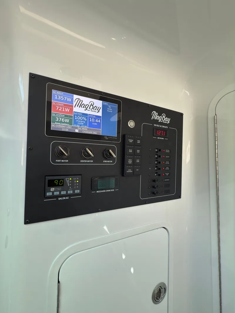 Slide: The Image of Control panel of 2025 Mag Bay 38 CC boat with digital displays and switches. - 9