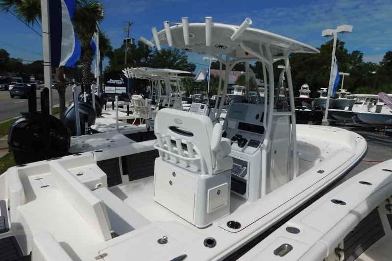 Slide: The Image of 2026 Pathfinder 2400 TRS boat with center console, displayed outdoors under a clear blue sky. - 1