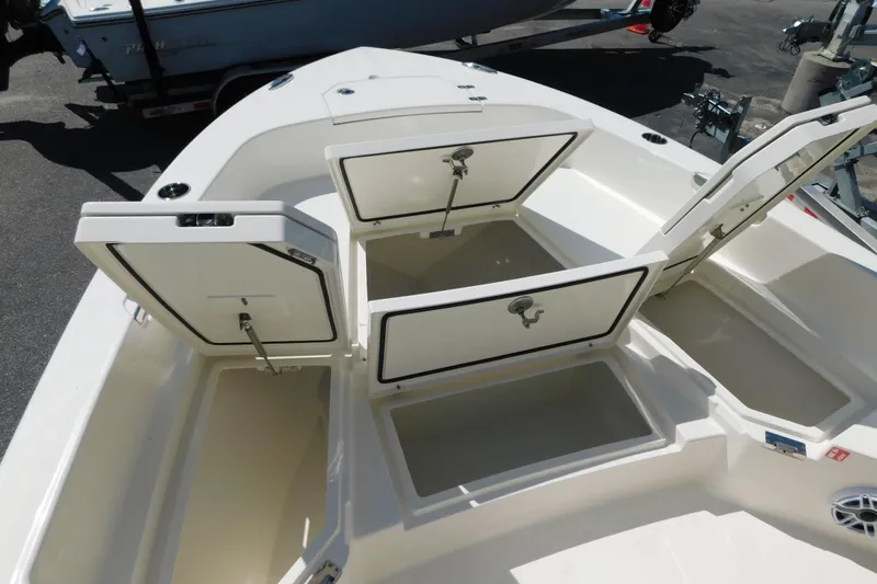 Slide: The Image of 2026 Pathfinder 2400 TRS boat with open storage compartments on deck. - 14