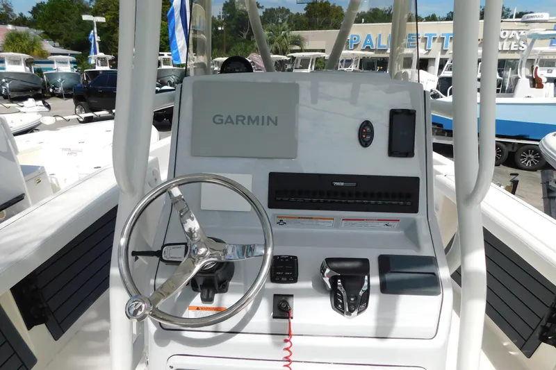 Slide: The Image of 2026 Pathfinder 2400 TRS boat console with Garmin navigation system and steering wheel. - 2