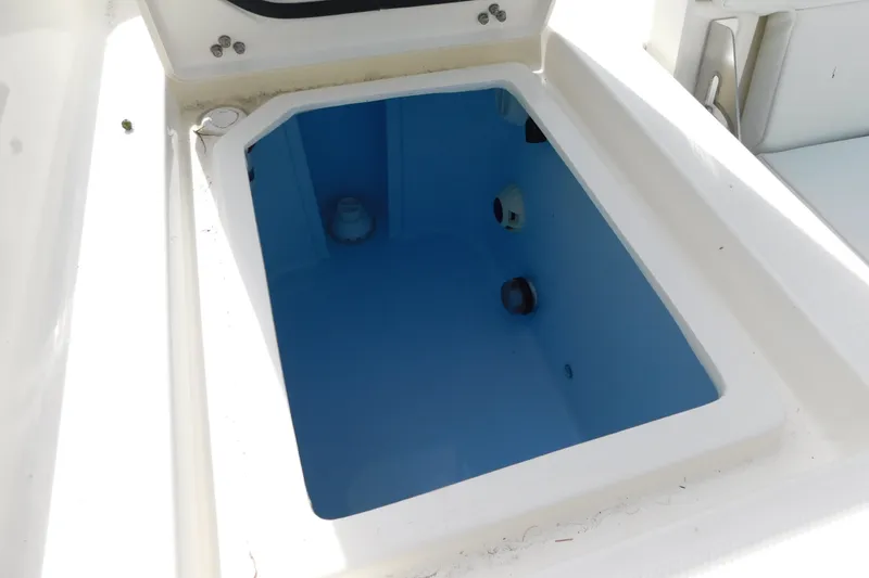 Slide: The Image of Open storage compartment on 2026 Pathfinder 2400 TRS boat, featuring a blue interior. - 20